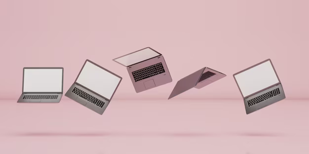 Several laptops levitate on a pink background