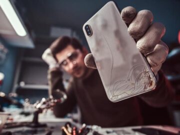 Man Showing Smartphone with Broken Body