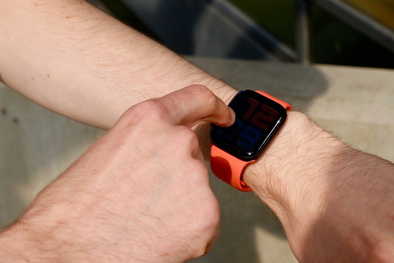 a man touching his Apple Watch screen