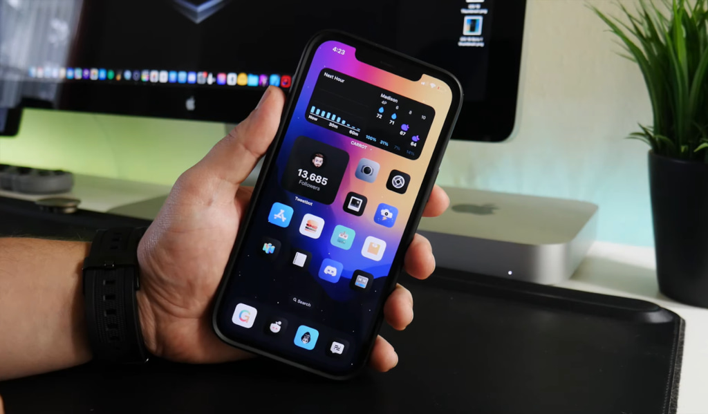 iPhone with customized app icons and widgets on a desk