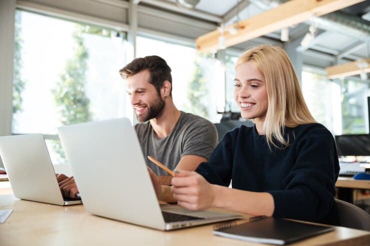 People with Laptops Concentrating on Work